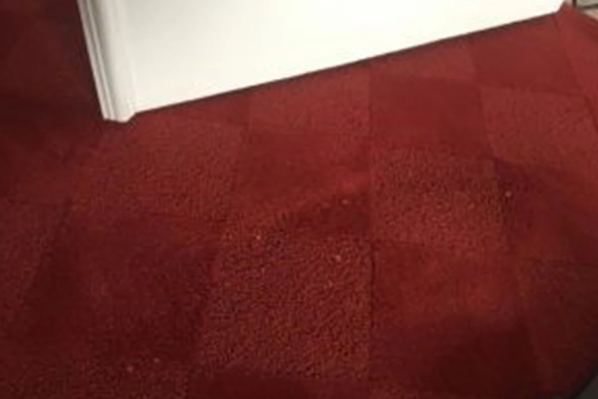 Red carpet with bleach spots before color correction