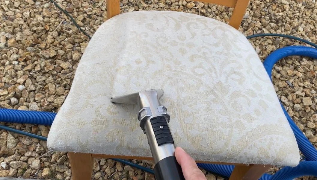 Upholstery cleaning tool on a patterned chair seat